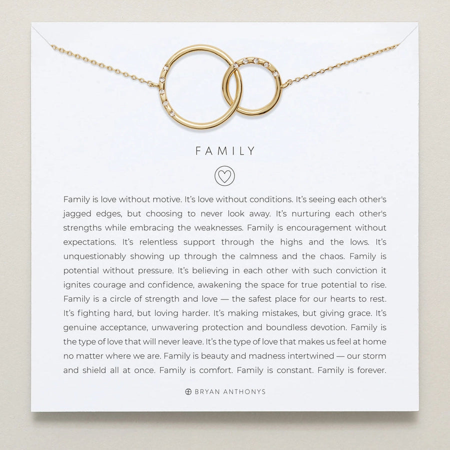 Gold necklace with interlocking rings on a card with 'Family' message