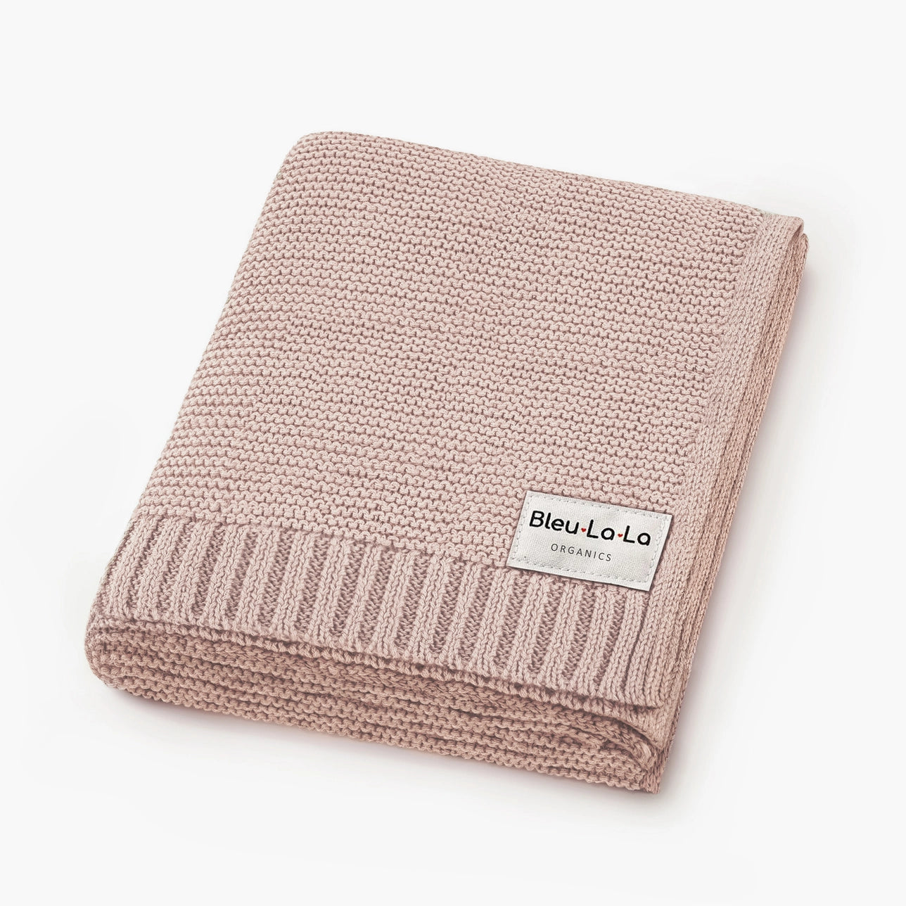 Pink knitted blanket with a label on a white background