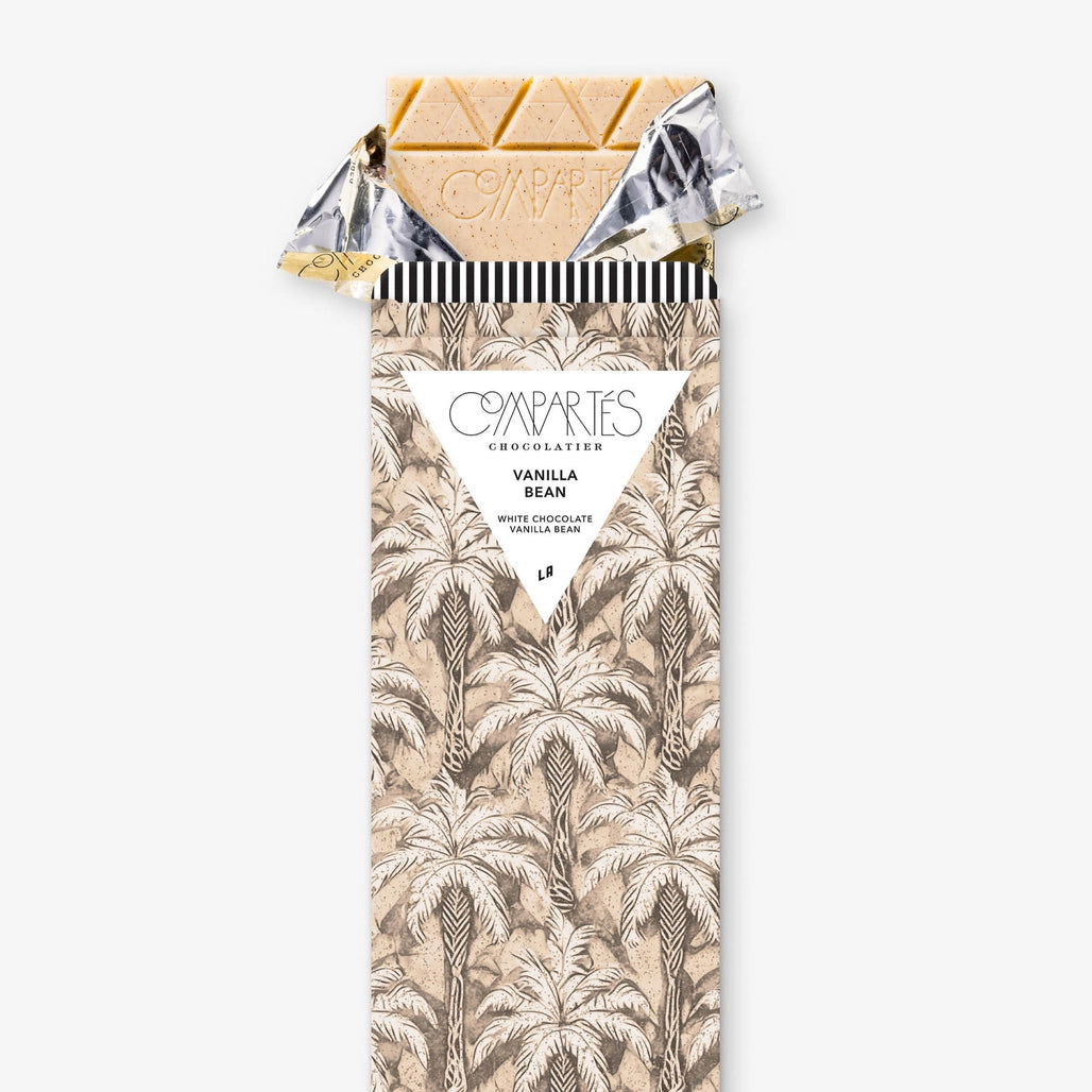 Vanilla bean chocolate bar with decorative packaging on a white background by Compartés