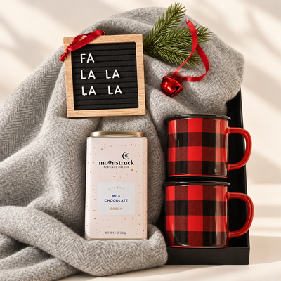 Gift box with herringbone blanket, Moonstruck hot chocolate, buffalo plaid mugs, and ornament