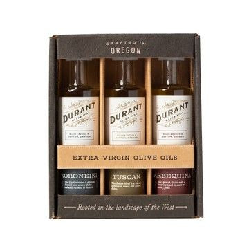 Pasta kit with 'Six Seasons of Pasta' book, Duran olive oil bottles,  jacobsen italian salt, tea towel, olive wood pasta spoon, gold measuring spoons on a white surface.