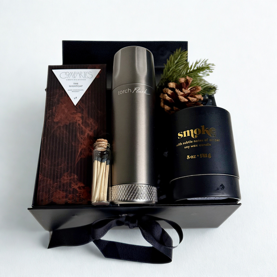 Gift box with grey flask, chocolate, black candle and matches