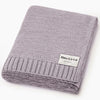 Folded knit blanket with 'Bleu La La Organics' label on a white background