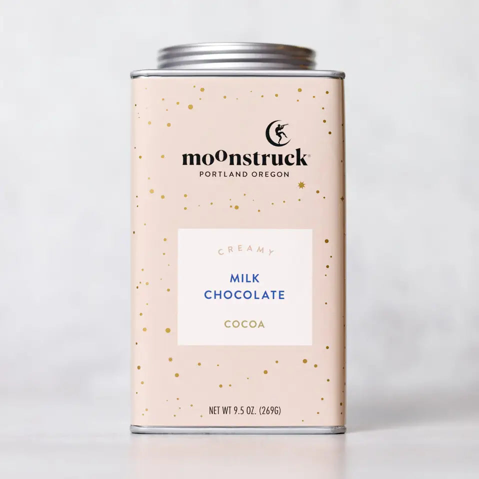 Moonstruck creamy milk chocolate cocoa canister on a light gray background