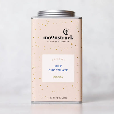 Moonstruck creamy milk chocolate cocoa canister on a light gray background