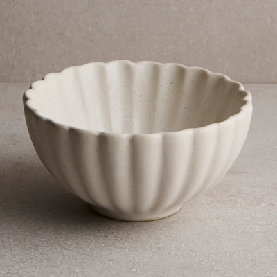 White ceramic bowl with ribbed texture on a gray background