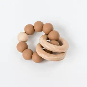 Wood and silicone baby teething rings on a white background