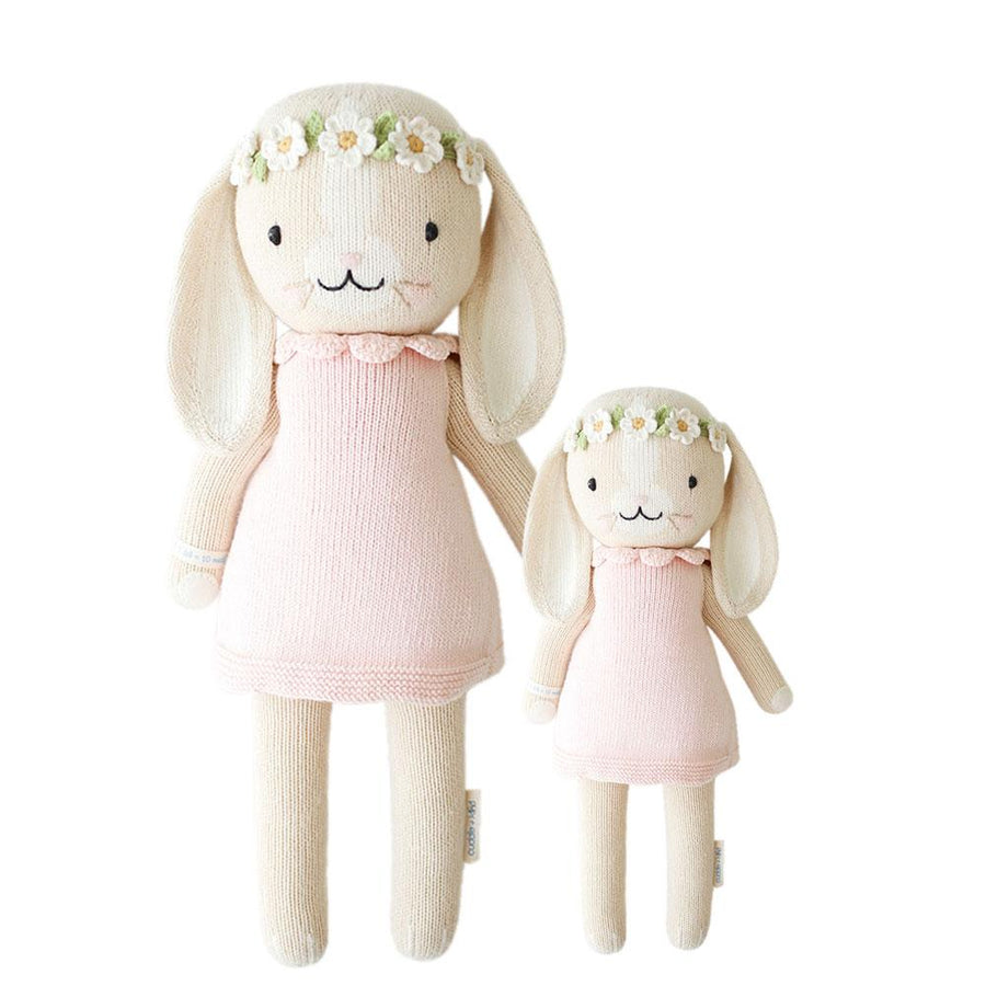 Handmade bunny from cuddle+kind, pink blanket, silicone teething ring, hatch sound machine on a white background